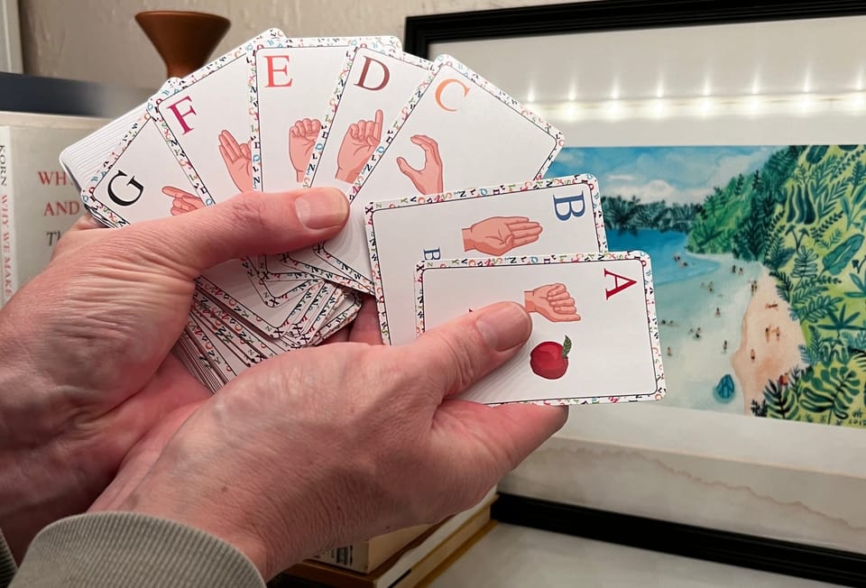 ASL Cards Fanned out with A through G showing the letters and signs